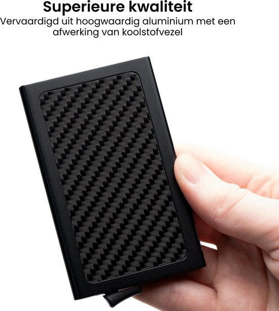 Hand houdt een zwart aluminium object met een koolstofvezel afwerking in detail zichtbaar.