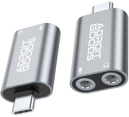 Twee zilverkleurige AdroitGoods adapters met USB-C en audioaansluitingen in modern design